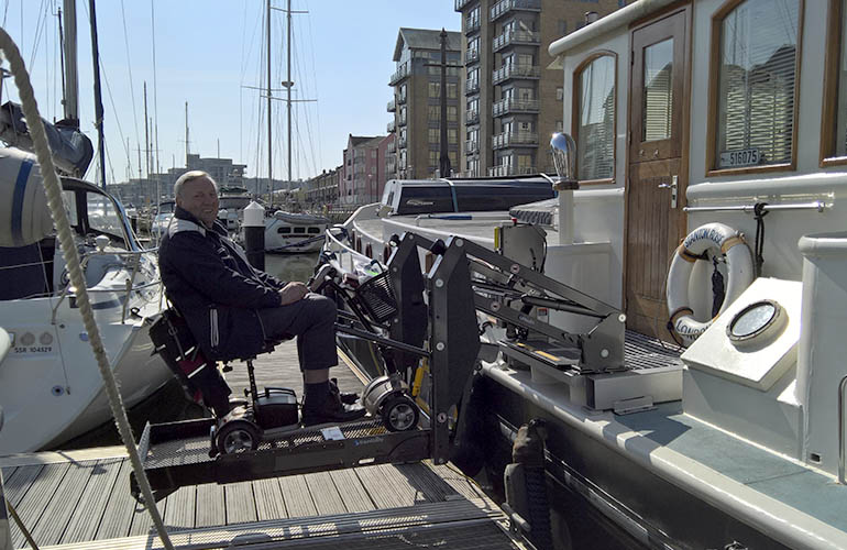 Boarding a boat in a mobility scooter made simple with a wheelchair lift.