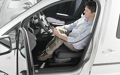 Man adjusting his seat on a Turny Evo by using the hand control
