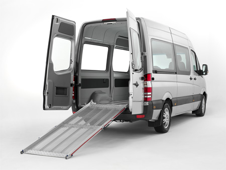 Van with the back doors open showing an unfolded tailboard ramp
