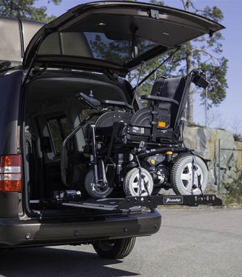 Joey Lift lifting a wheelchair into the rear hatch of a car