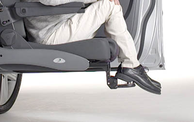 Man sitting on swivel seat with feet on foot rest
