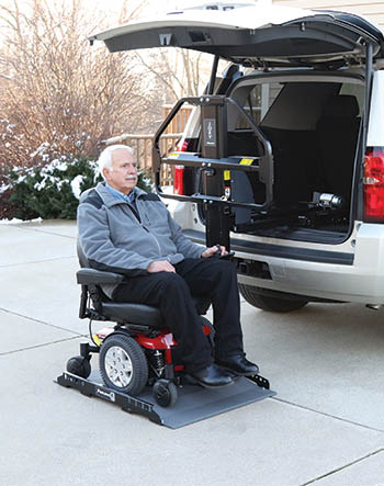  Homme à bord d'un Joey Lift avec son fauteuil roulant électrique
