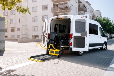 E-Series wheelchair lift folded out from a van